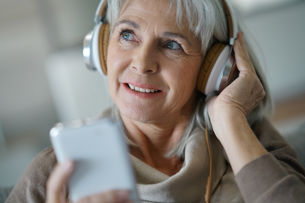 Senior woman listening to music on headphones