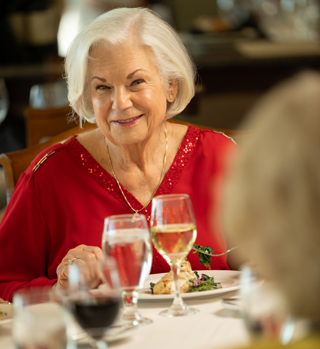 A close up of a senior woman eating fine dining