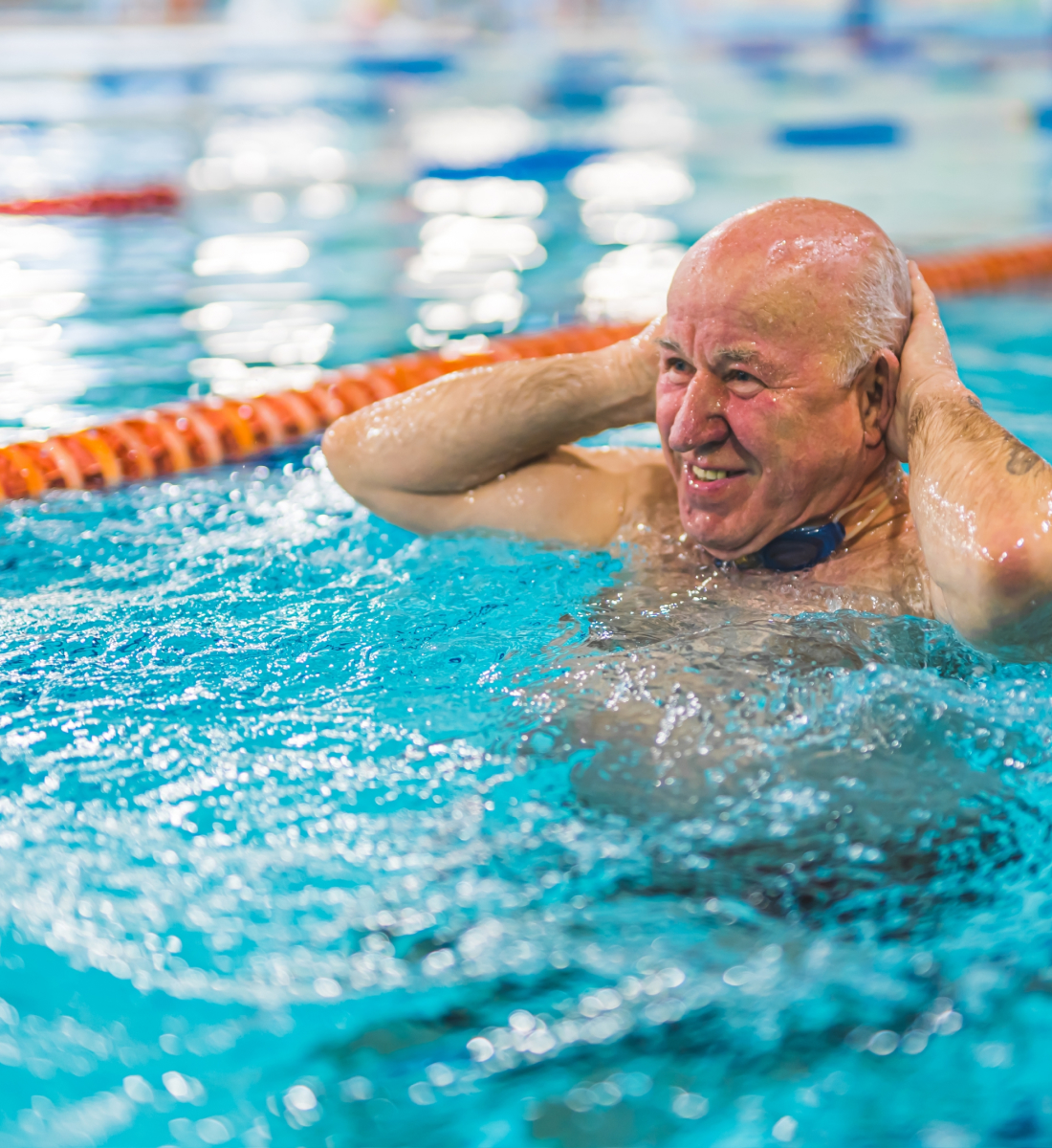 A senior man swimming in a swim lane