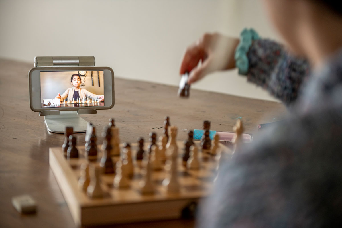 two people playing chess over video chat