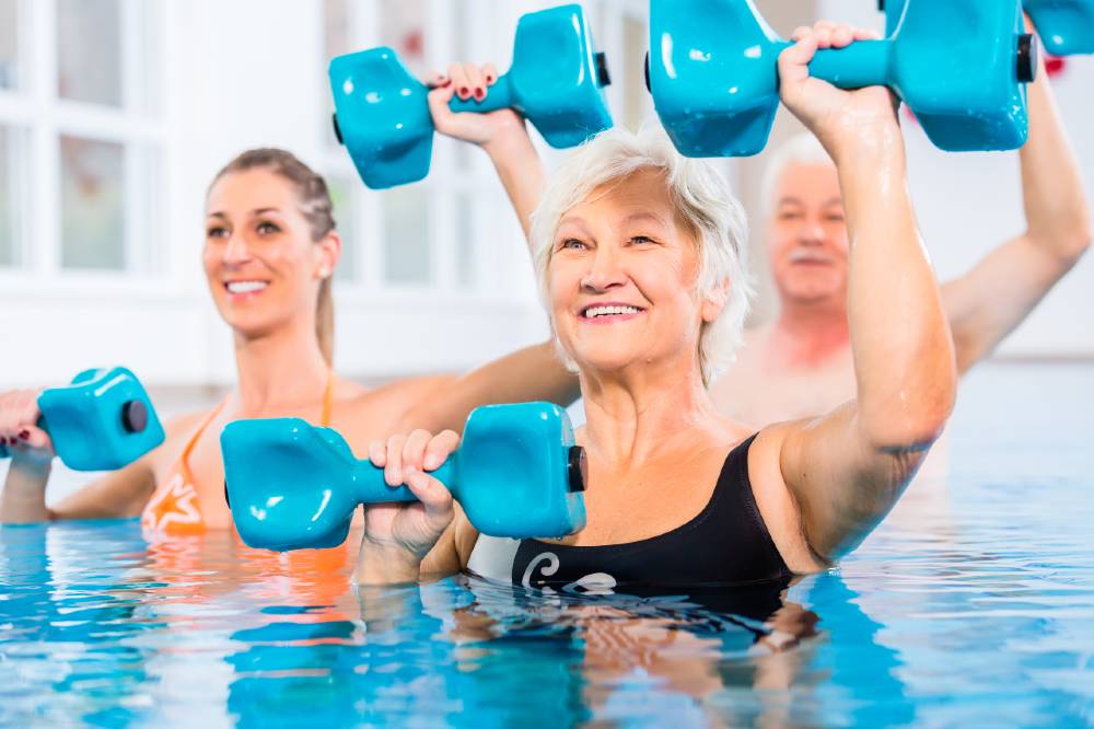 Senior women participating in water aerobics 