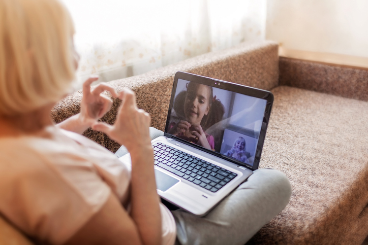 a senior woman video chatting with her granddaughter